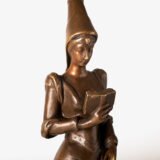 Art Nouveau bronze and red marble sculpture “Châtelaine XIV S”. Beautiful Art Nouveau bronze sculpture titled “Châtelaine XIV S”, 14th century Lady of the castle. It depicts a Lady of the Middle Ages with headdress and long-tailed dress walking absorbed reading a book. She stands on a stepped pedestal of red marble