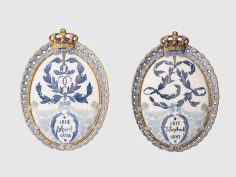 Royal Copenhagen porcelain plates by Arnold Krog, 19th century. Commemorative medallion plates, made by the renowned Arnold Krog for Royal Copenhagen, celebrate the 80th birthday of Denmark's King Christian IX and his wife, Queen Louise of Hesse-Kassel.