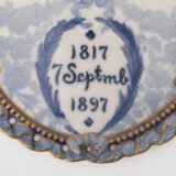 Royal Copenhagen porcelain plates by Arnold Krog, 19th century. Commemorative medallion plates, made by the renowned Arnold Krog for Royal Copenhagen, celebrate the 80th birthday of Denmark's King Christian IX and his wife, Queen Louise of Hesse-Kassel.