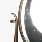 Italian Art Deco Bronze Lyre Mirror, a 1930's collector's item. Discover this refined Italian Art Deco bronze dressing table mirror, whose lyre design and beveled glass make it a unique piece full of character.