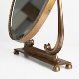 Italian Art Deco Bronze Lyre Mirror, a 1930's collector's item. Discover this refined Italian Art Deco bronze dressing table mirror, whose lyre design and beveled glass make it a unique piece full of character.