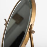 Italian Art Deco Bronze Lyre Mirror, a 1930's collector's item. Discover this refined Italian Art Deco bronze dressing table mirror, whose lyre design and beveled glass make it a unique piece full of character.