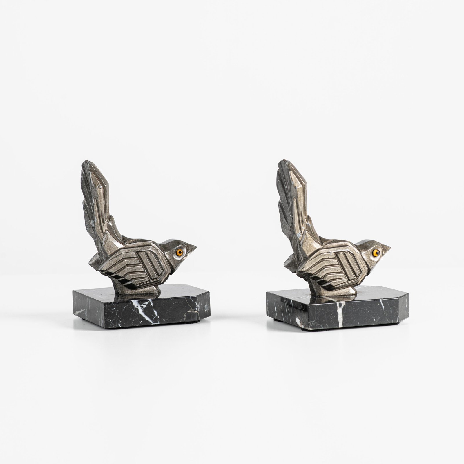 Hippolyte Moreau Art Deco Bookends, Cubist Birds in marble and spelter, 1930s This is an elegant pair of Art Deco bookends, signed by the celebrated French sculptor Hippolyte Moreau. These 1930s masterpieces depict two stylized birds with a bold cubist design.