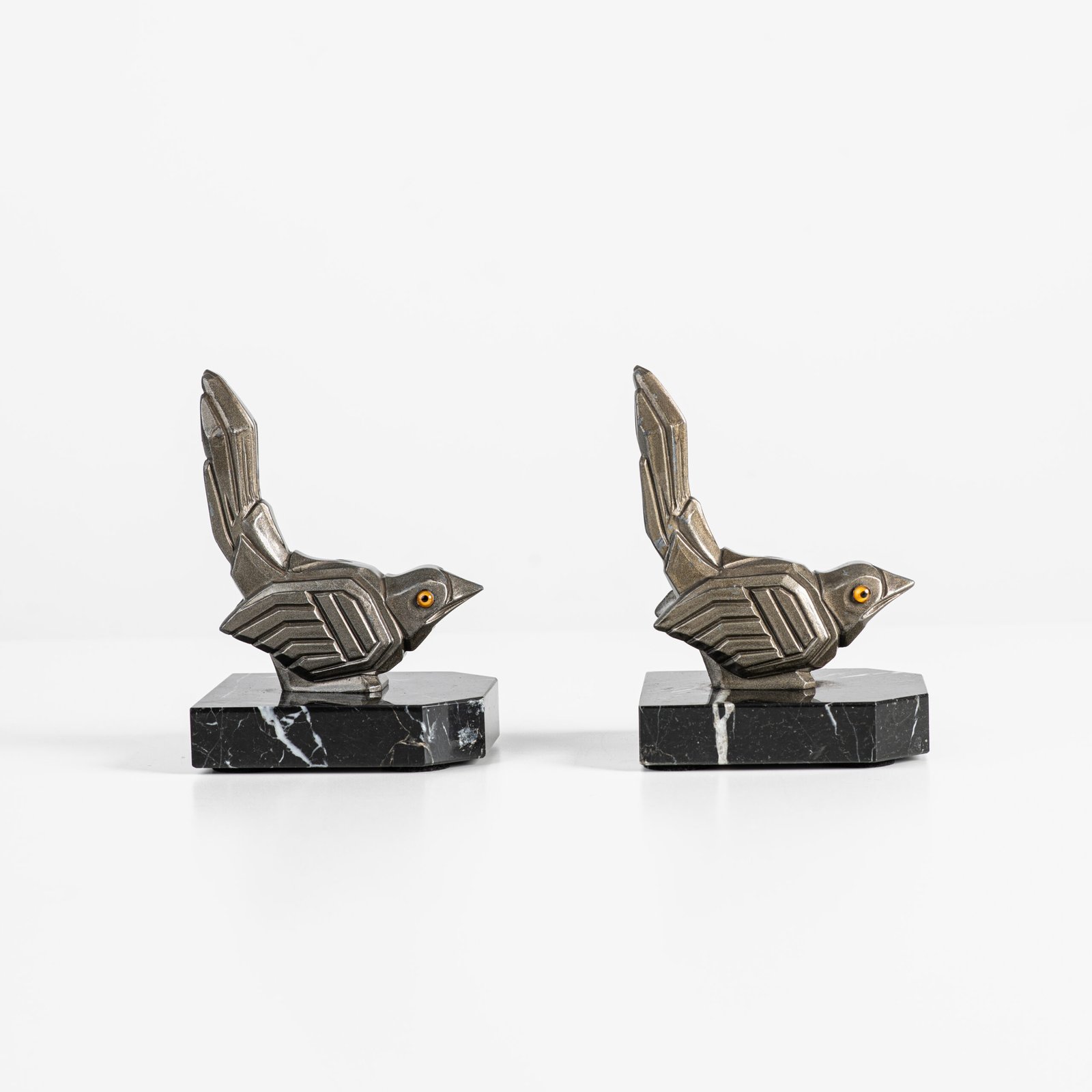 Hippolyte Moreau Art Deco Bookends, Cubist Birds in marble and spelter, 1930s This is an elegant pair of Art Deco bookends, signed by the celebrated French sculptor Hippolyte Moreau. These 1930s masterpieces depict two stylized birds with a bold cubist design.