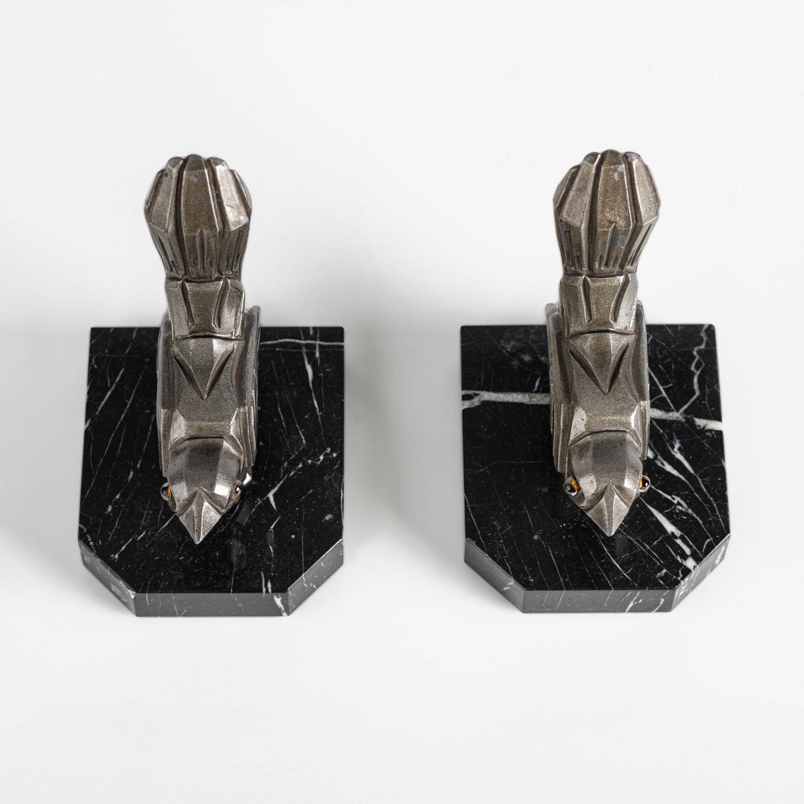 Hippolyte Moreau Art Deco Bookends, Cubist Birds in marble and spelter, 1930s This is an elegant pair of Art Deco bookends, signed by the celebrated French sculptor Hippolyte Moreau. These 1930s masterpieces depict two stylized birds with a bold cubist design.