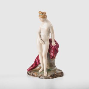 18th-century hard-paste porcelain sculpture titled “La Baigneuse”, modeled and signed in relief by Johann Peter Melchior, Höchst manufactory ca. 1775. Neoclassical nude figure with enamel decoration and fired gold detailing.