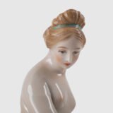18th-century hard-paste porcelain sculpture titled “La Baigneuse”, modeled and signed in relief by Johann Peter Melchior, Höchst manufactory ca. 1775. Neoclassical nude figure with enamel decoration and fired gold detailing.