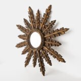 Elegant sunburst mirror hand-carved in elm and gilded with gold leaf, made in Viana do Castelo (Portugal) circa 1920–1930. Original mirror, refined patina, and exceptional craftsmanship.