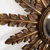Elegant sunburst mirror hand-carved in elm and gilded with gold leaf, made in Viana do Castelo (Portugal) circa 1920–1930. Original mirror, refined patina, and exceptional craftsmanship.
