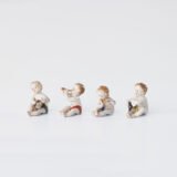 Delicate set of four hand-painted porcelain putti musicians crafted by the Höchst manufactory in Germany, circa 1767–1779. Each figure depicts a different musical instrument and bears the distinctive Höchst wheel mark with radiating spokes. Approx. 1.77 × 1.77 × 1.18 in. A fine example of late Rococo artistry.
