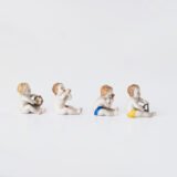 Delicate set of four hand-painted porcelain putti musicians crafted by the Höchst manufactory in Germany, circa 1767–1779. Each figure depicts a different musical instrument and bears the distinctive Höchst wheel mark with radiating spokes. Approx. 1.77 × 1.77 × 1.18 in. A fine example of late Rococo artistry.