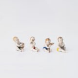 Delicate set of four hand-painted porcelain putti musicians crafted by the Höchst manufactory in Germany, circa 1767–1779. Each figure depicts a different musical instrument and bears the distinctive Höchst wheel mark with radiating spokes. Approx. 1.77 × 1.77 × 1.18 in. A fine example of late Rococo artistry.