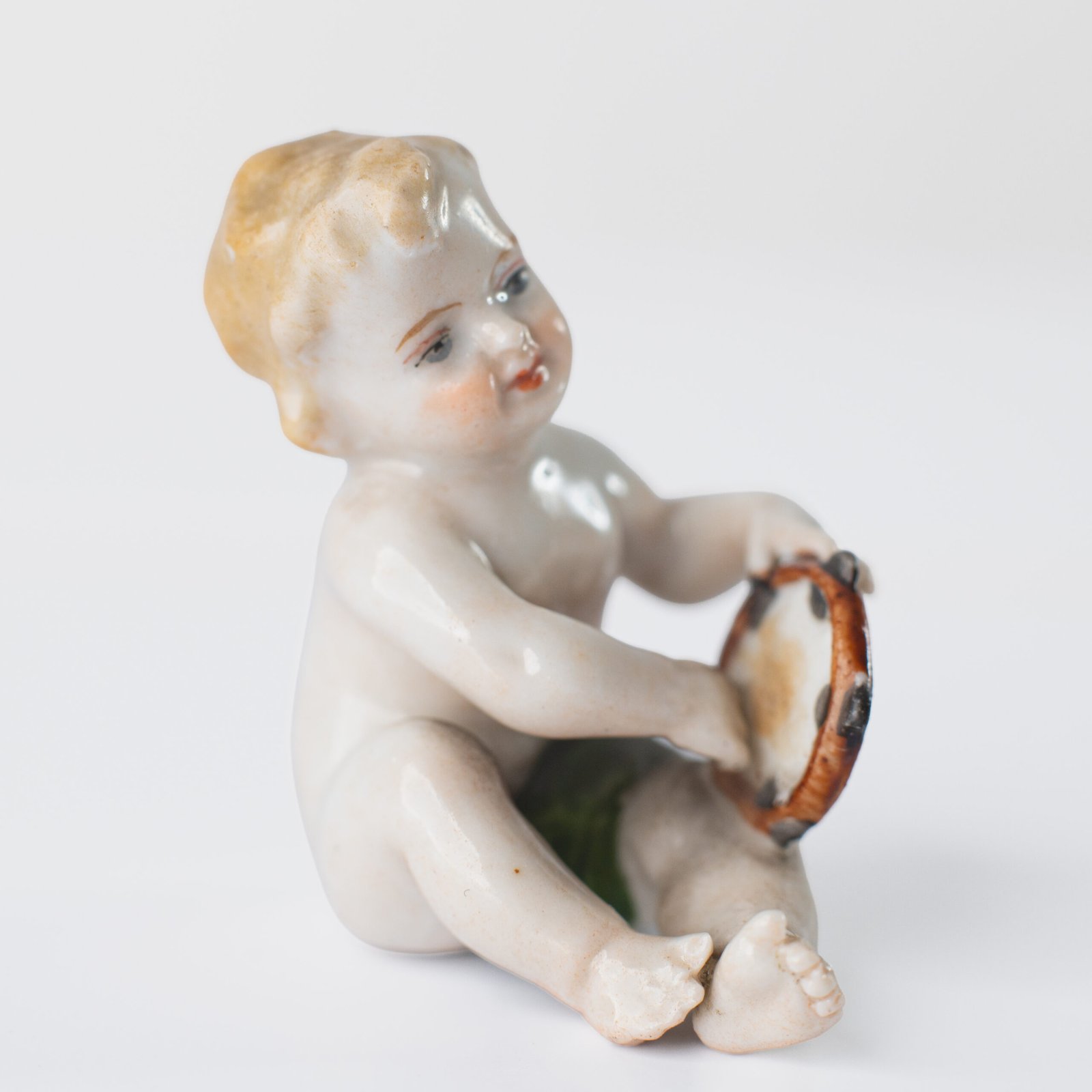 Delicate set of four hand-painted porcelain putti musicians crafted by the Höchst manufactory in Germany, circa 1767–1779. Each figure depicts a different musical instrument and bears the distinctive Höchst wheel mark with radiating spokes. Approx. 1.77 × 1.77 × 1.18 in. A fine example of late Rococo artistry.