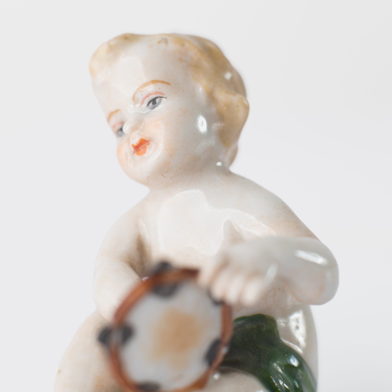 Delicate set of four hand-painted porcelain putti musicians crafted by the Höchst manufactory in Germany, circa 1767–1779. Each figure depicts a different musical instrument and bears the distinctive Höchst wheel mark with radiating spokes. Approx. 1.77 × 1.77 × 1.18 in. A fine example of late Rococo artistry.
