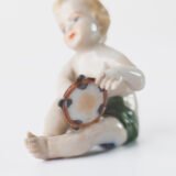 Delicate set of four hand-painted porcelain putti musicians crafted by the Höchst manufactory in Germany, circa 1767–1779. Each figure depicts a different musical instrument and bears the distinctive Höchst wheel mark with radiating spokes. Approx. 1.77 × 1.77 × 1.18 in. A fine example of late Rococo artistry.