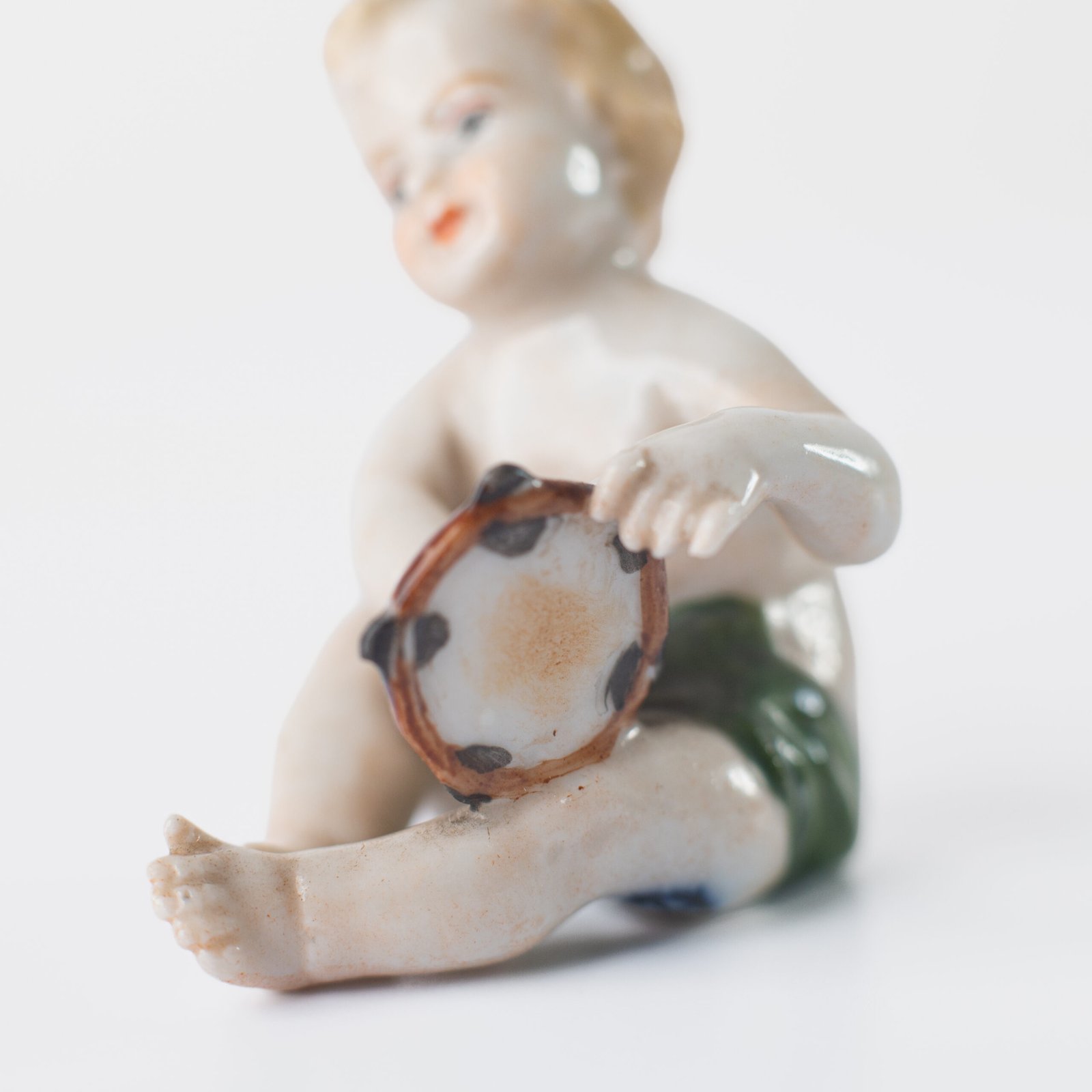 Delicate set of four hand-painted porcelain putti musicians crafted by the Höchst manufactory in Germany, circa 1767–1779. Each figure depicts a different musical instrument and bears the distinctive Höchst wheel mark with radiating spokes. Approx. 1.77 × 1.77 × 1.18 in. A fine example of late Rococo artistry.