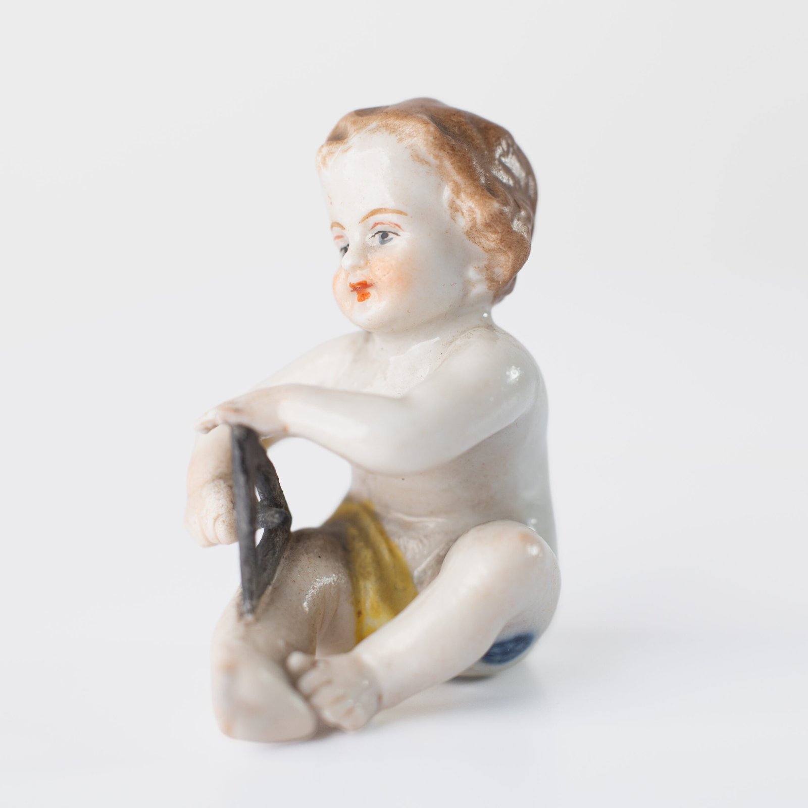 Delicate set of four hand-painted porcelain putti musicians crafted by the Höchst manufactory in Germany, circa 1767–1779. Each figure depicts a different musical instrument and bears the distinctive Höchst wheel mark with radiating spokes. Approx. 1.77 × 1.77 × 1.18 in. A fine example of late Rococo artistry.