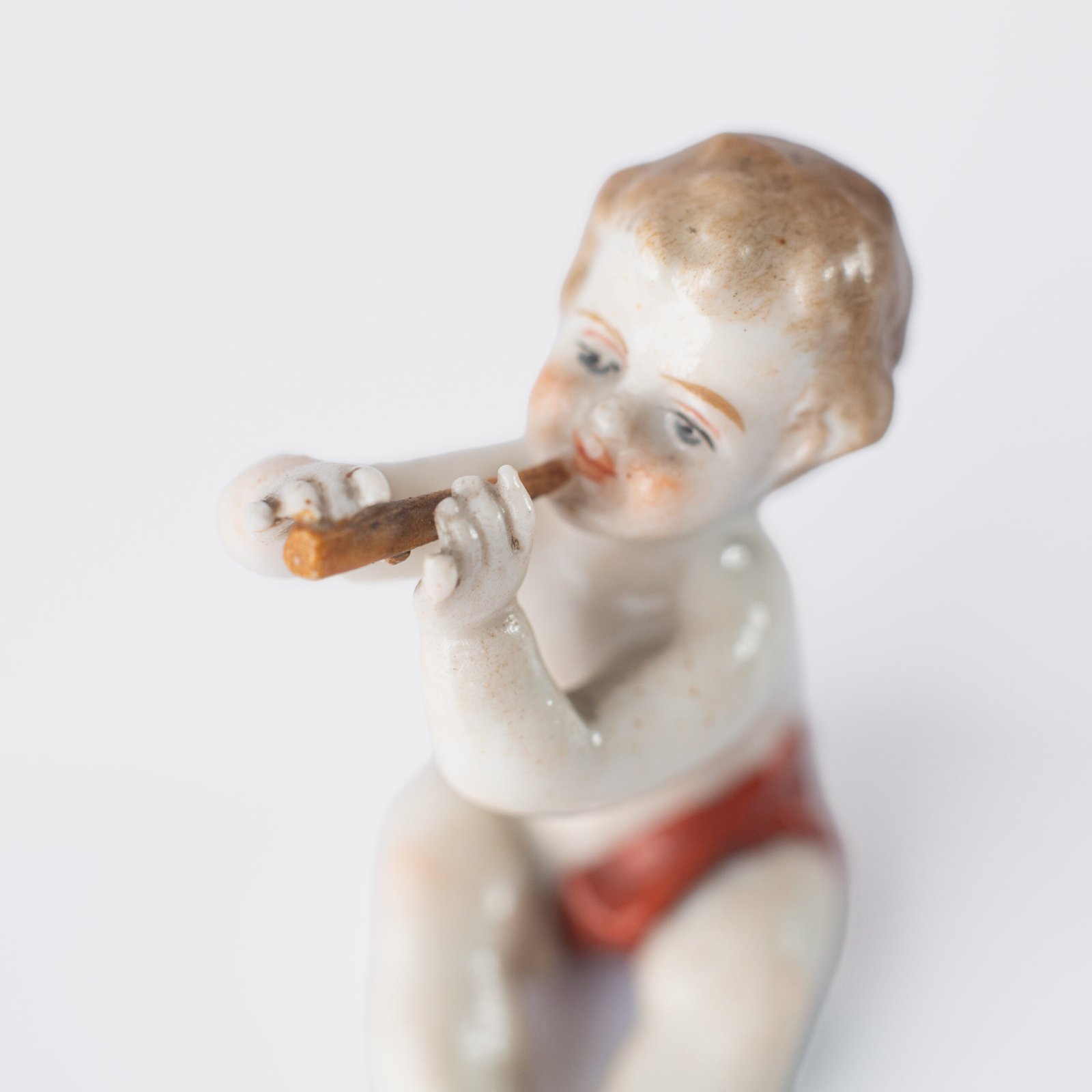 Delicate set of four hand-painted porcelain putti musicians crafted by the Höchst manufactory in Germany, circa 1767–1779. Each figure depicts a different musical instrument and bears the distinctive Höchst wheel mark with radiating spokes. Approx. 1.77 × 1.77 × 1.18 in. A fine example of late Rococo artistry.