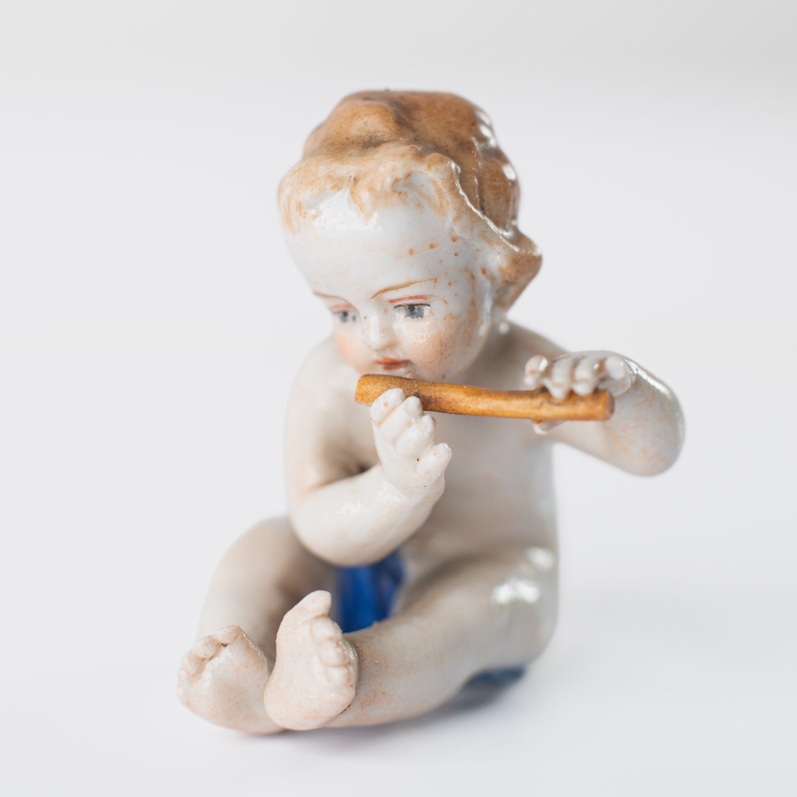 Delicate set of four hand-painted porcelain putti musicians crafted by the Höchst manufactory in Germany, circa 1767–1779. Each figure depicts a different musical instrument and bears the distinctive Höchst wheel mark with radiating spokes. Approx. 1.77 × 1.77 × 1.18 in. A fine example of late Rococo artistry.