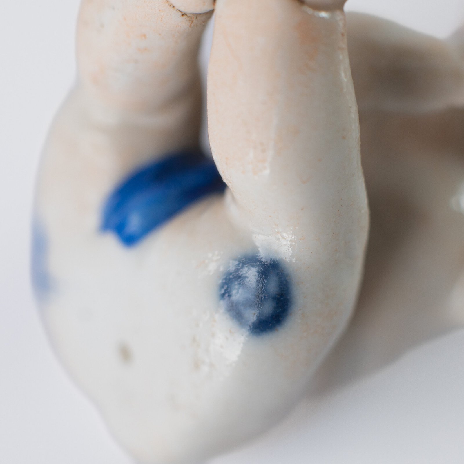 Delicate set of four hand-painted porcelain putti musicians crafted by the Höchst manufactory in Germany, circa 1767–1779. Each figure depicts a different musical instrument and bears the distinctive Höchst wheel mark with radiating spokes. Approx. 1.77 × 1.77 × 1.18 in. A fine example of late Rococo artistry.