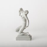 Art Deco porcelain sculpture of Cleopatra kneeling with a snake, in white glazed porcelain by Herend, signed in relief by sculptor Szigethy Nagy István, circa 1930.