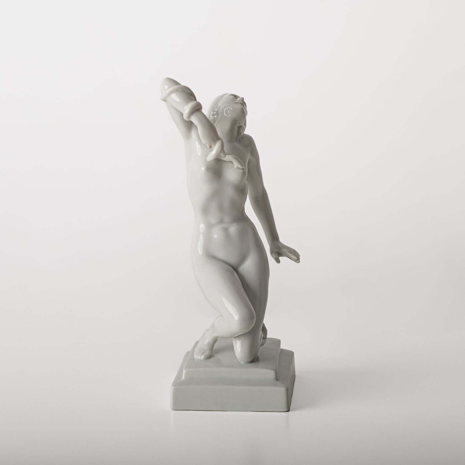 Art Deco porcelain sculpture of Cleopatra kneeling with a snake, in white glazed porcelain by Herend, signed in relief by sculptor Szigethy Nagy István, circa 1930.