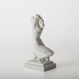 Art Deco porcelain sculpture of Cleopatra kneeling with a snake, in white glazed porcelain by Herend, signed in relief by sculptor Szigethy Nagy István, circa 1930.