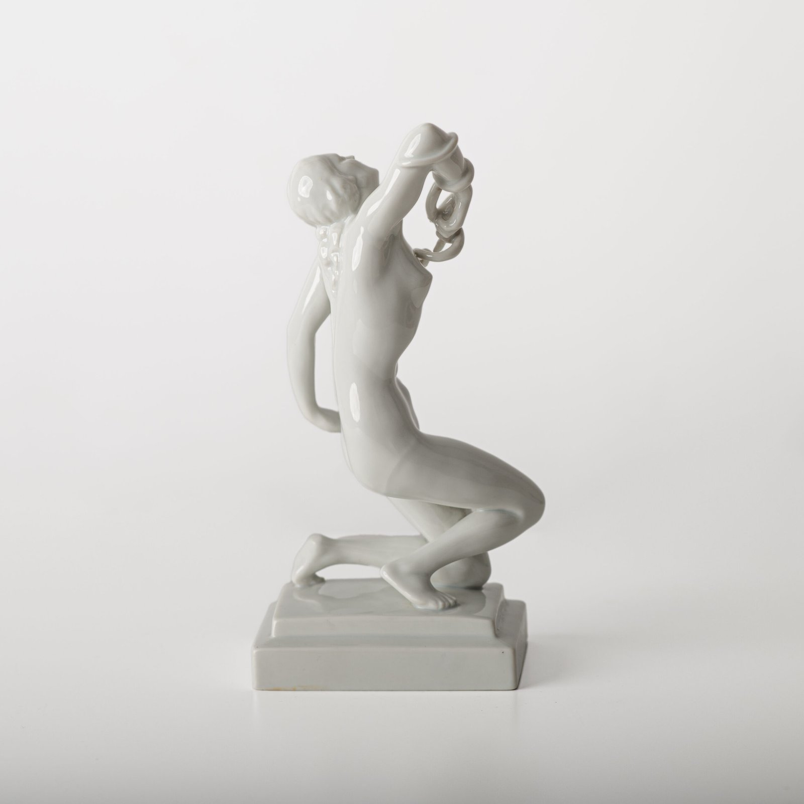 Art Deco porcelain sculpture of Cleopatra kneeling with a snake, in white glazed porcelain by Herend, signed in relief by sculptor Szigethy Nagy István, circa 1930.