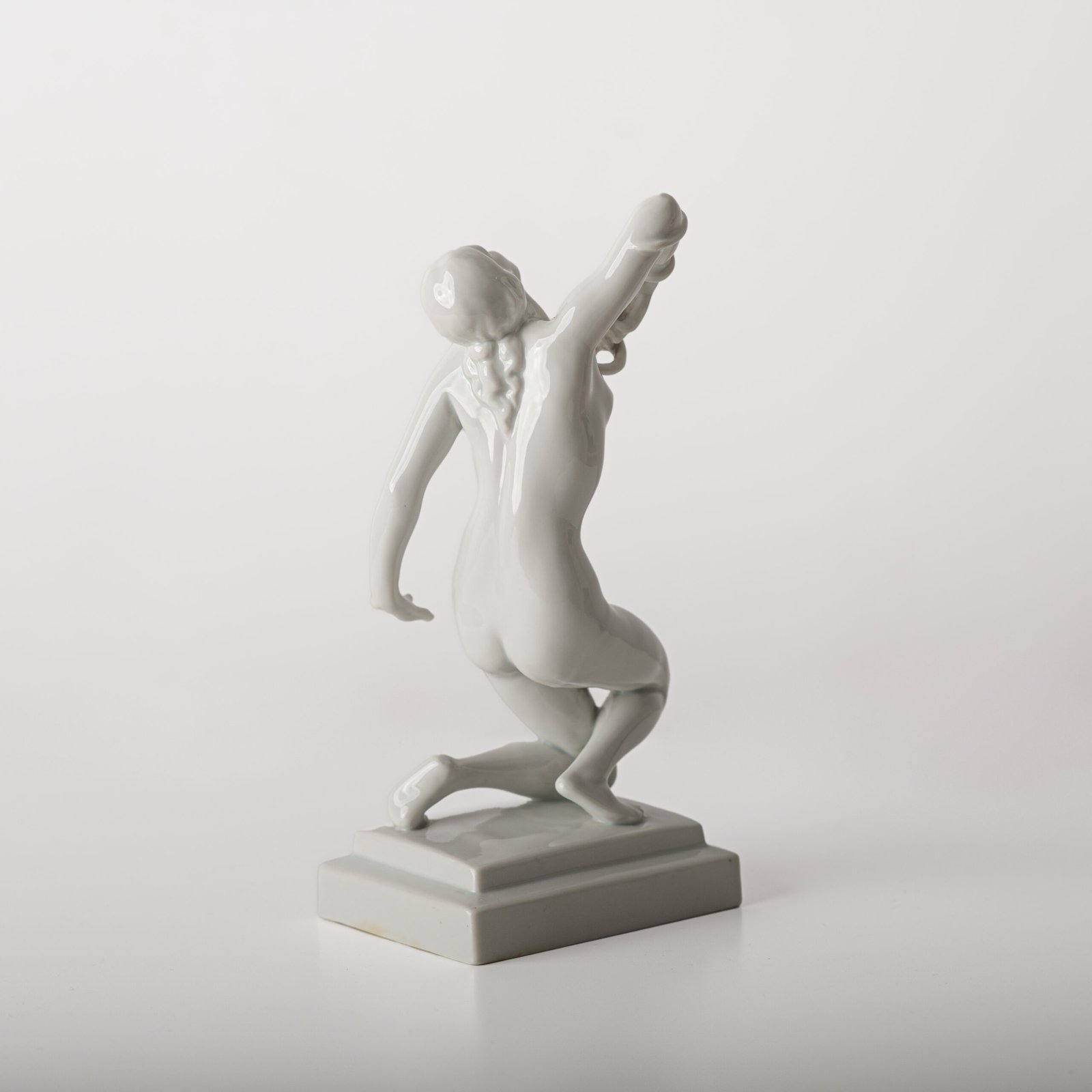 Art Deco porcelain sculpture of Cleopatra kneeling with a snake, in white glazed porcelain by Herend, signed in relief by sculptor Szigethy Nagy István, circa 1930.