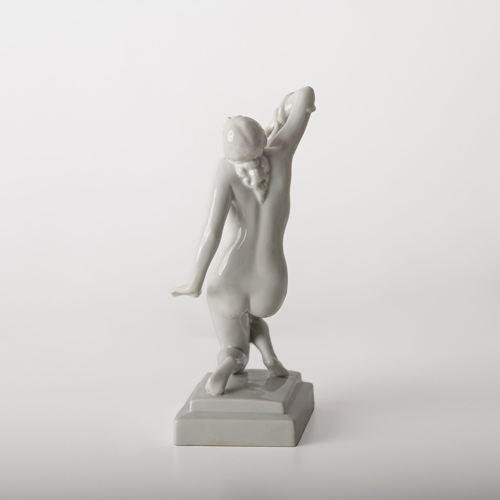 Art Deco porcelain sculpture of Cleopatra kneeling with a snake, in white glazed porcelain by Herend, signed in relief by sculptor Szigethy Nagy István, circa 1930.