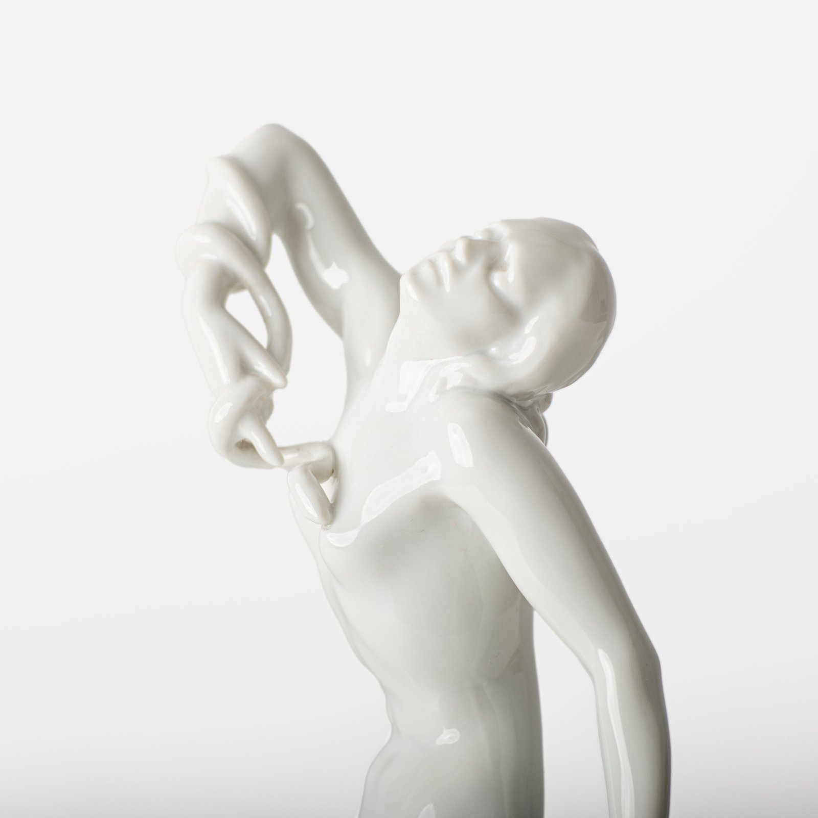 Art Deco porcelain sculpture of Cleopatra kneeling with a snake, in white glazed porcelain by Herend, signed in relief by sculptor Szigethy Nagy István, circa 1930.