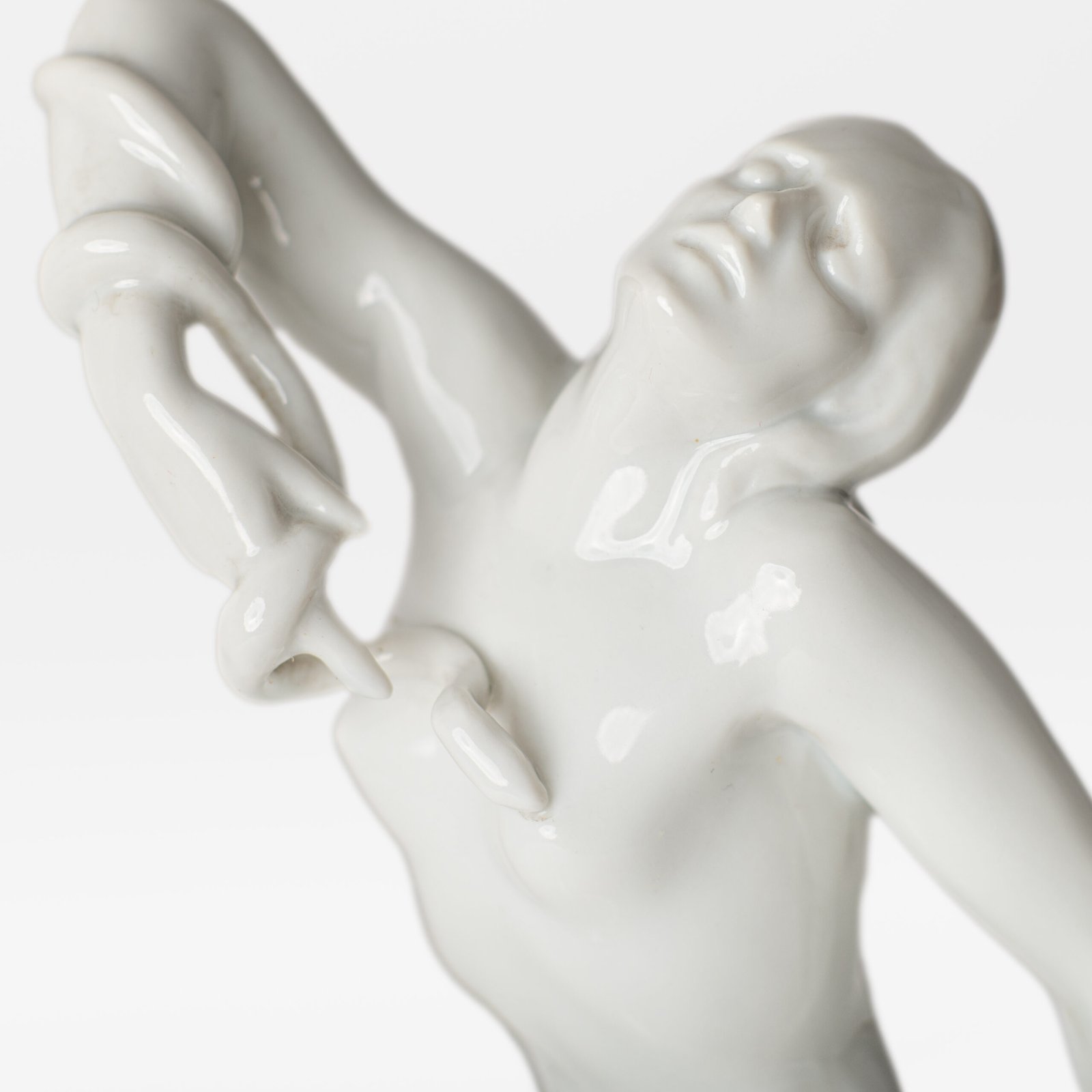 Art Deco porcelain sculpture of Cleopatra kneeling with a snake, in white glazed porcelain by Herend, signed in relief by sculptor Szigethy Nagy István, circa 1930.