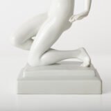 Art Deco porcelain sculpture of Cleopatra kneeling with a snake, in white glazed porcelain by Herend, signed in relief by sculptor Szigethy Nagy István, circa 1930.