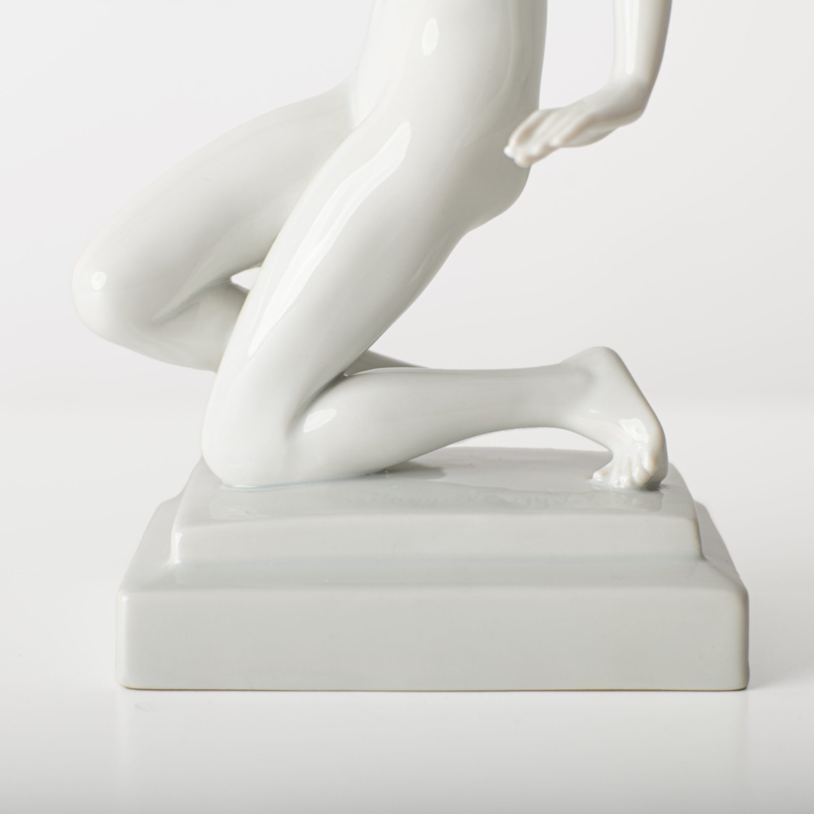 Art Deco porcelain sculpture of Cleopatra kneeling with a snake, in white glazed porcelain by Herend, signed in relief by sculptor Szigethy Nagy István, circa 1930.