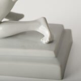Art Deco porcelain sculpture of Cleopatra kneeling with a snake, in white glazed porcelain by Herend, signed in relief by sculptor Szigethy Nagy István, circa 1930.