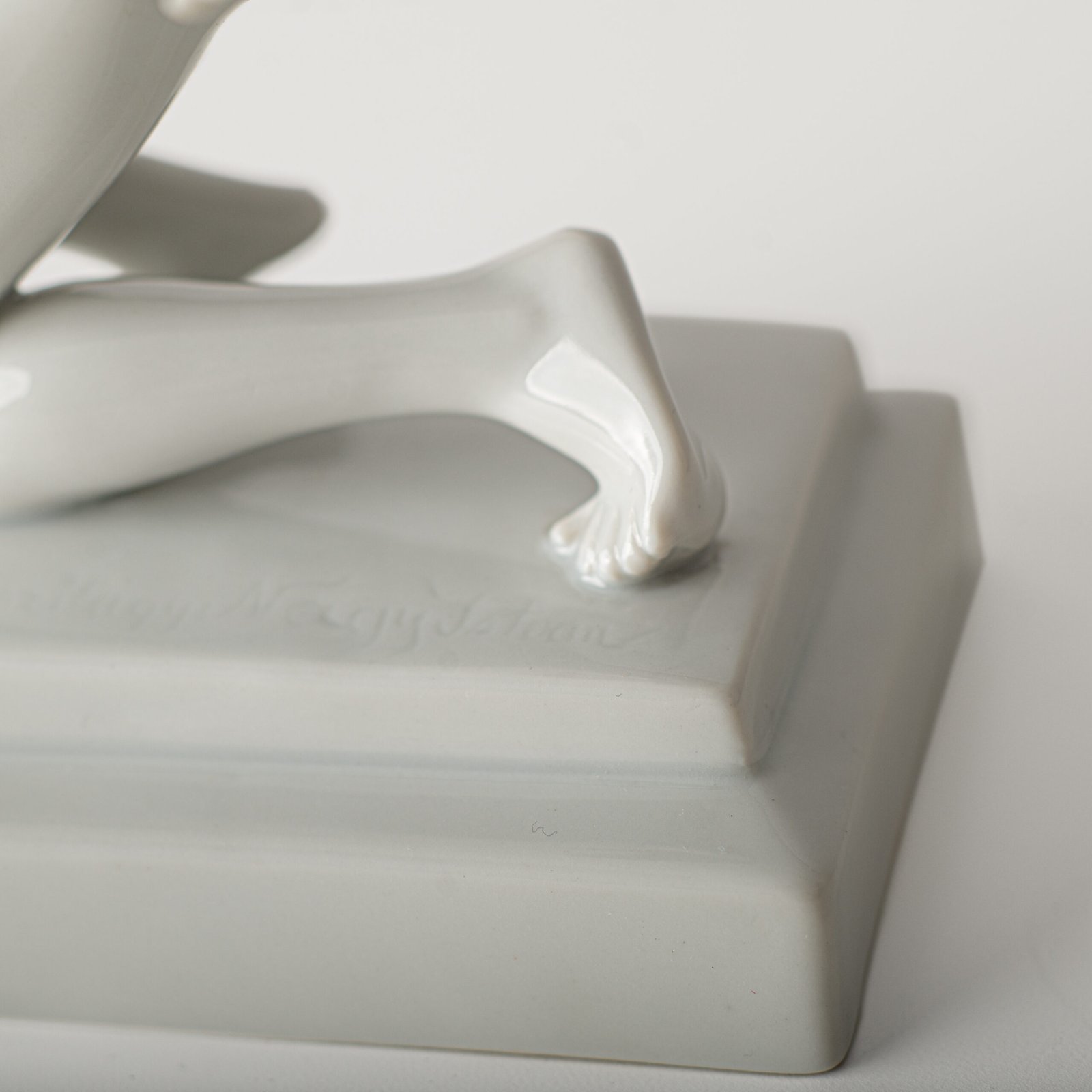 Art Deco porcelain sculpture of Cleopatra kneeling with a snake, in white glazed porcelain by Herend, signed in relief by sculptor Szigethy Nagy István, circa 1930.