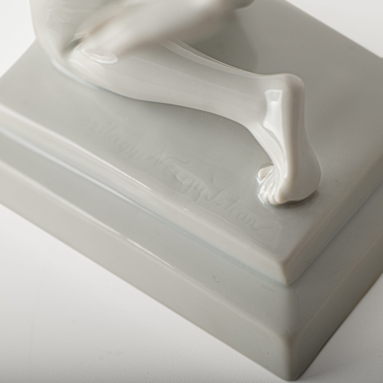 Art Deco porcelain sculpture of Cleopatra kneeling with a snake, in white glazed porcelain by Herend, signed in relief by sculptor Szigethy Nagy István, circa 1930.