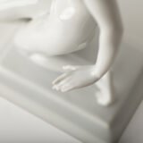 Art Deco porcelain sculpture of Cleopatra kneeling with a snake, in white glazed porcelain by Herend, signed in relief by sculptor Szigethy Nagy István, circa 1930.