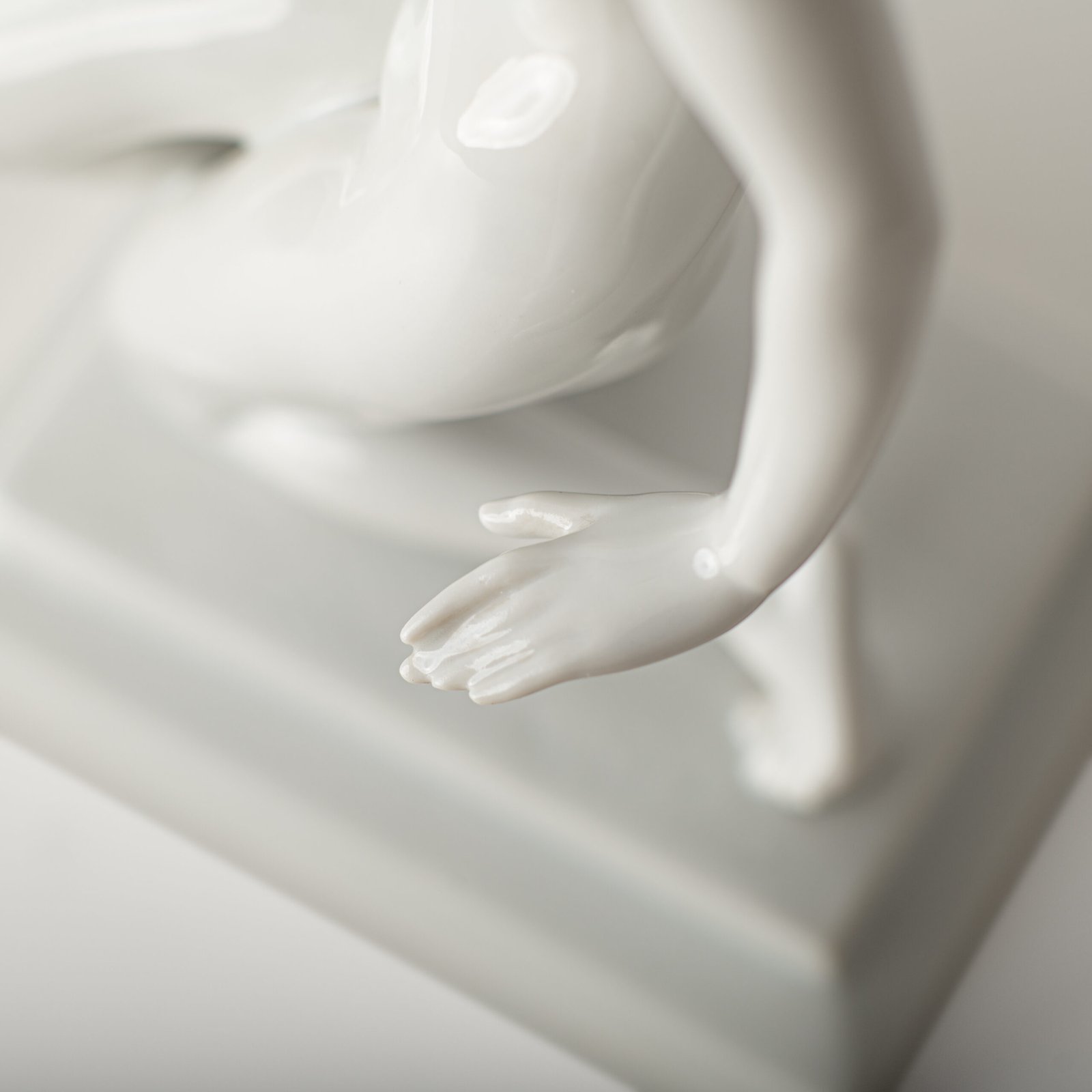 Art Deco porcelain sculpture of Cleopatra kneeling with a snake, in white glazed porcelain by Herend, signed in relief by sculptor Szigethy Nagy István, circa 1930.