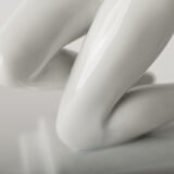 Art Deco porcelain sculpture of Cleopatra kneeling with a snake, in white glazed porcelain by Herend, signed in relief by sculptor Szigethy Nagy István, circa 1930.