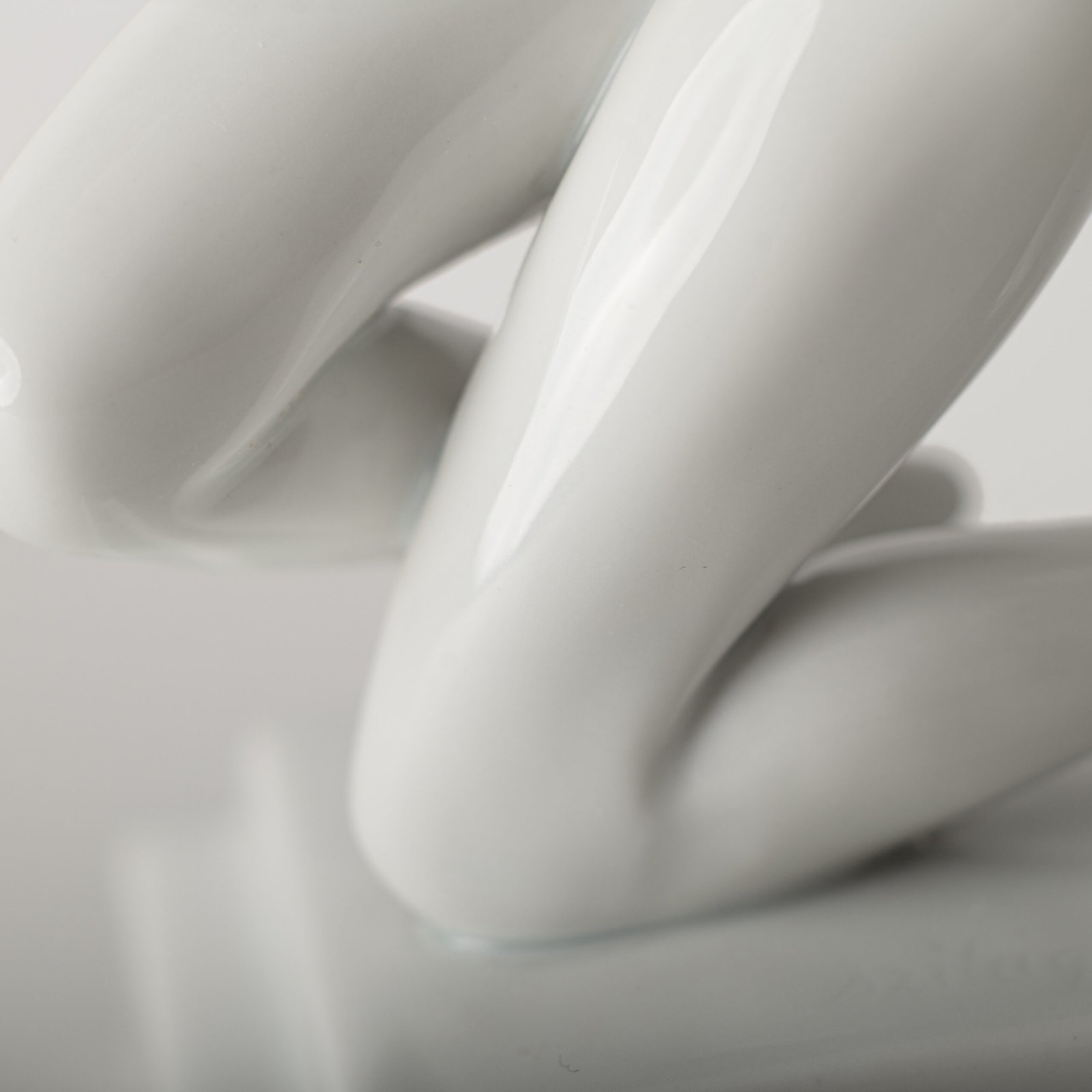 Art Deco porcelain sculpture of Cleopatra kneeling with a snake, in white glazed porcelain by Herend, signed in relief by sculptor Szigethy Nagy István, circa 1930.