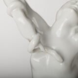 Art Deco porcelain sculpture of Cleopatra kneeling with a snake, in white glazed porcelain by Herend, signed in relief by sculptor Szigethy Nagy István, circa 1930.