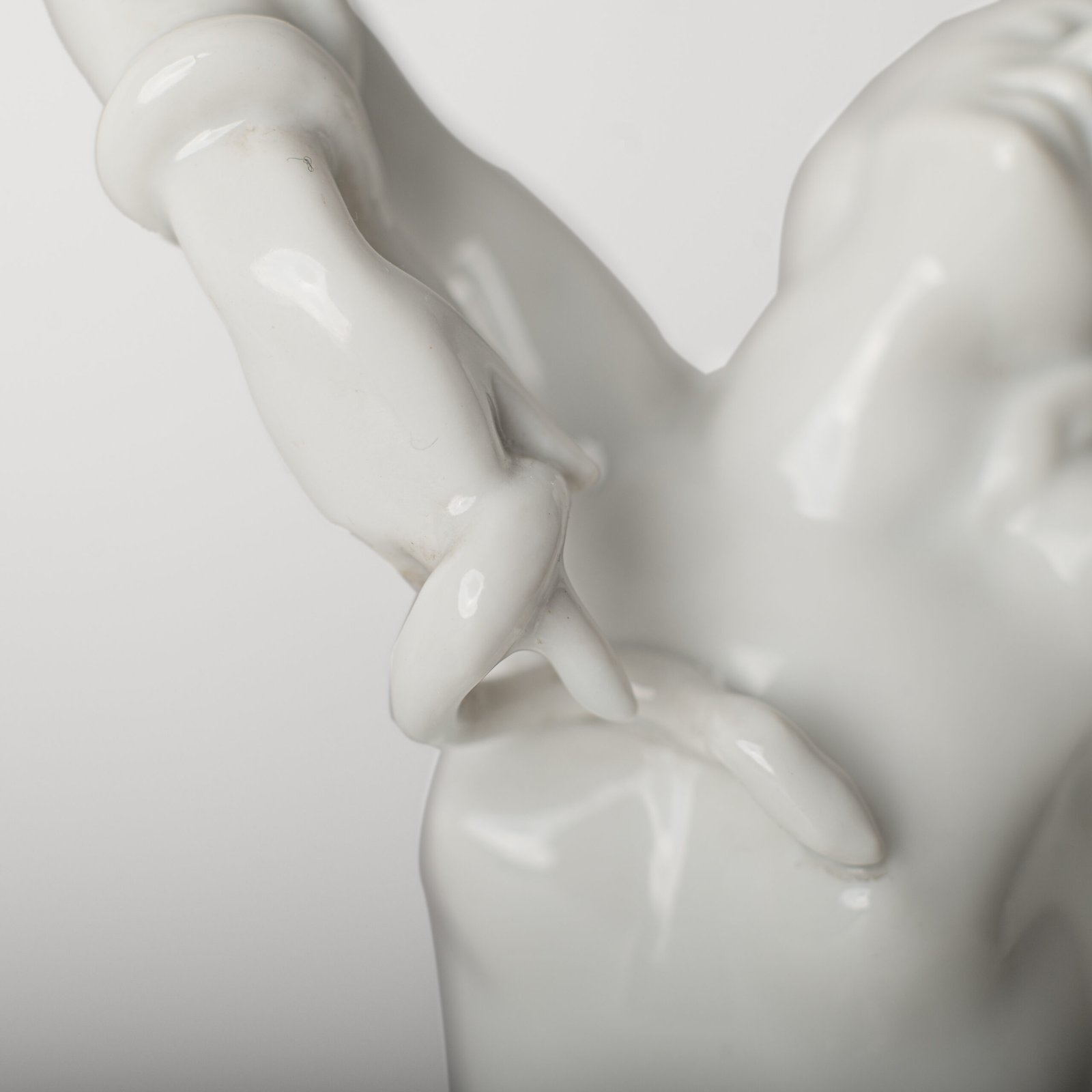 Art Deco porcelain sculpture of Cleopatra kneeling with a snake, in white glazed porcelain by Herend, signed in relief by sculptor Szigethy Nagy István, circa 1930.