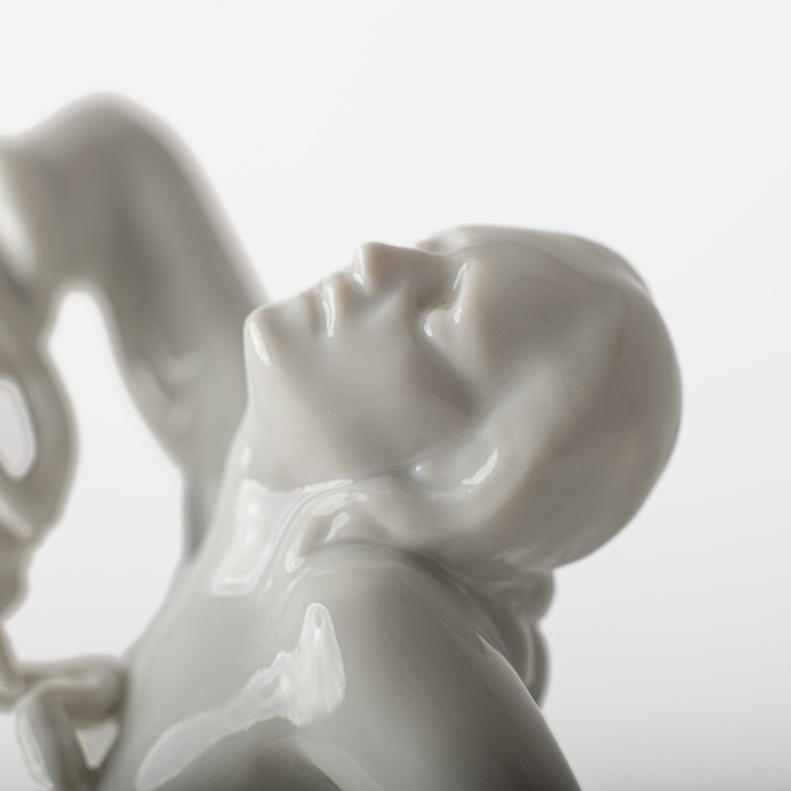 Art Deco porcelain sculpture of Cleopatra kneeling with a snake, in white glazed porcelain by Herend, signed in relief by sculptor Szigethy Nagy István, circa 1930.