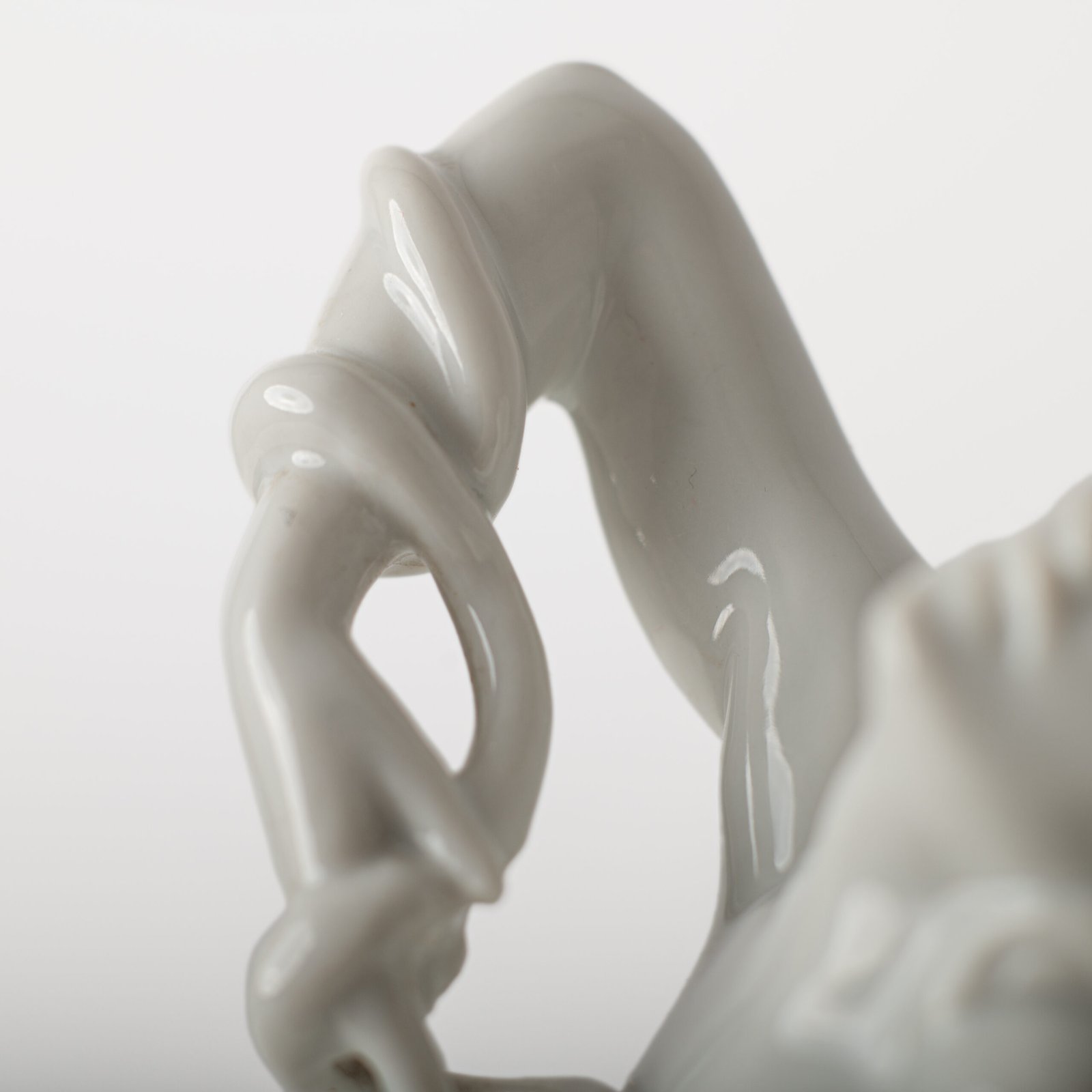 Art Deco porcelain sculpture of Cleopatra kneeling with a snake, in white glazed porcelain by Herend, signed in relief by sculptor Szigethy Nagy István, circa 1930.