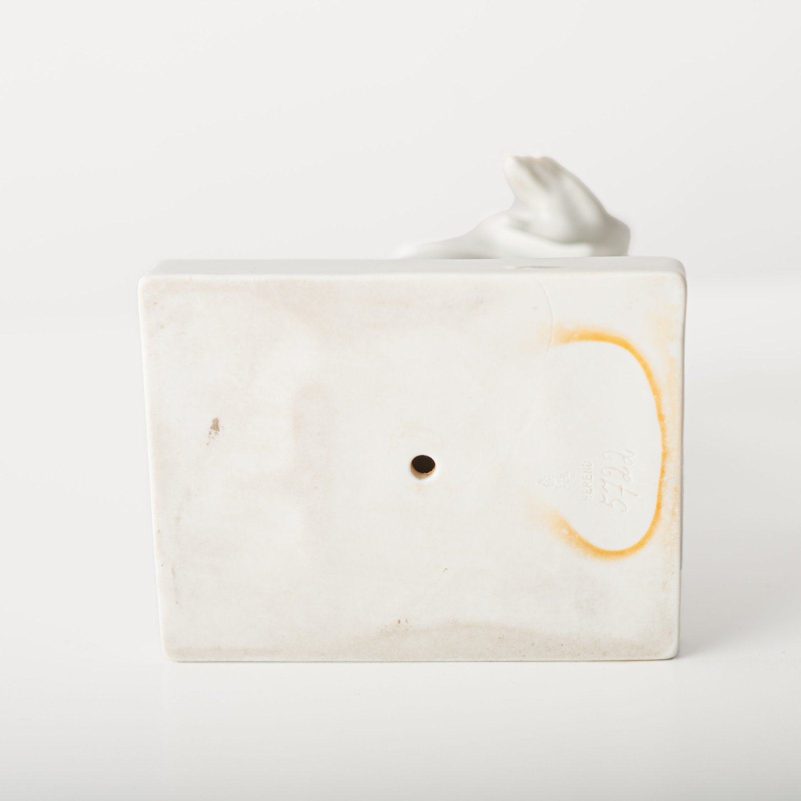 Art Deco porcelain sculpture of Cleopatra kneeling with a snake, in white glazed porcelain by Herend, signed in relief by sculptor Szigethy Nagy István, circa 1930.