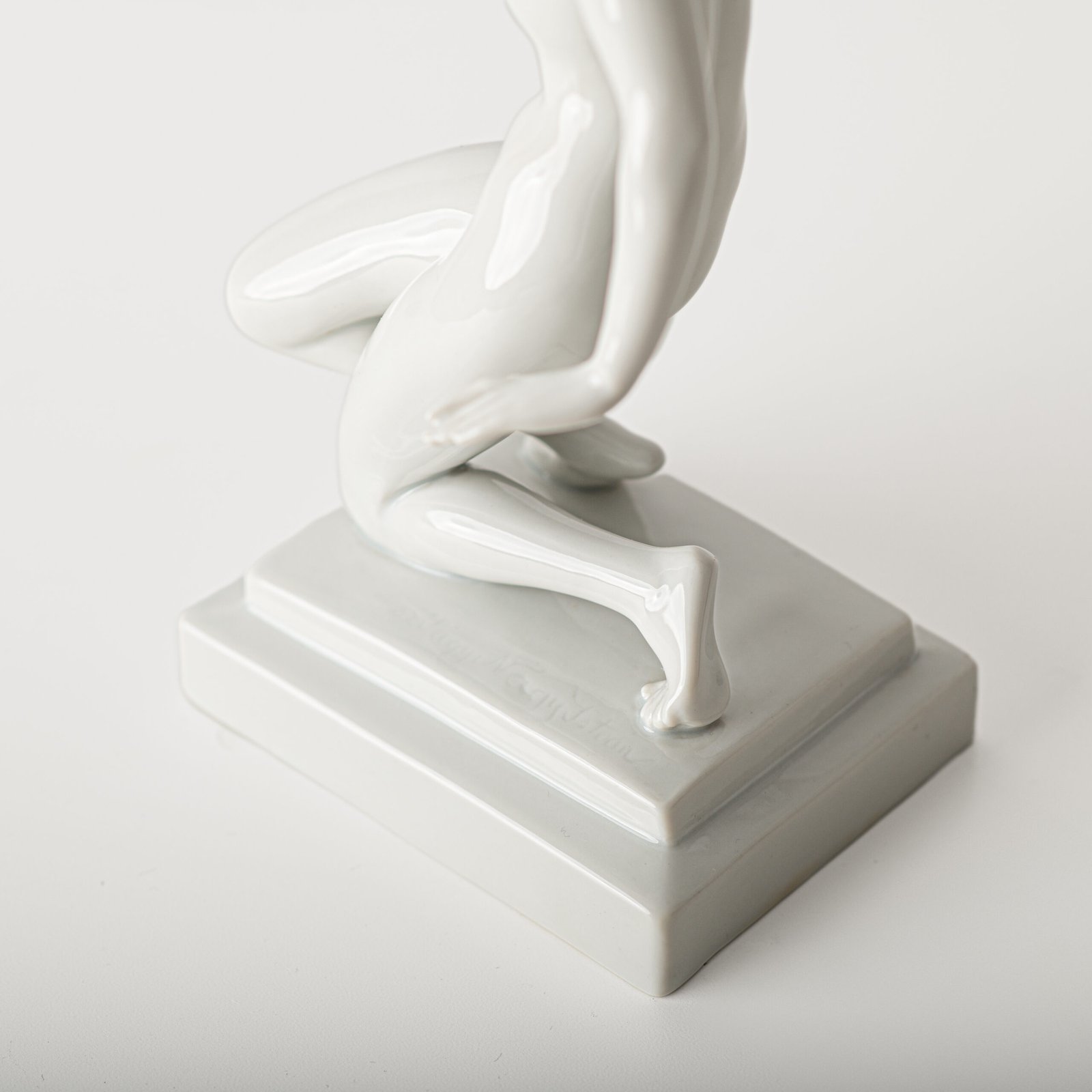 Art Deco porcelain sculpture of Cleopatra kneeling with a snake, in white glazed porcelain by Herend, signed in relief by sculptor Szigethy Nagy István, circa 1930.