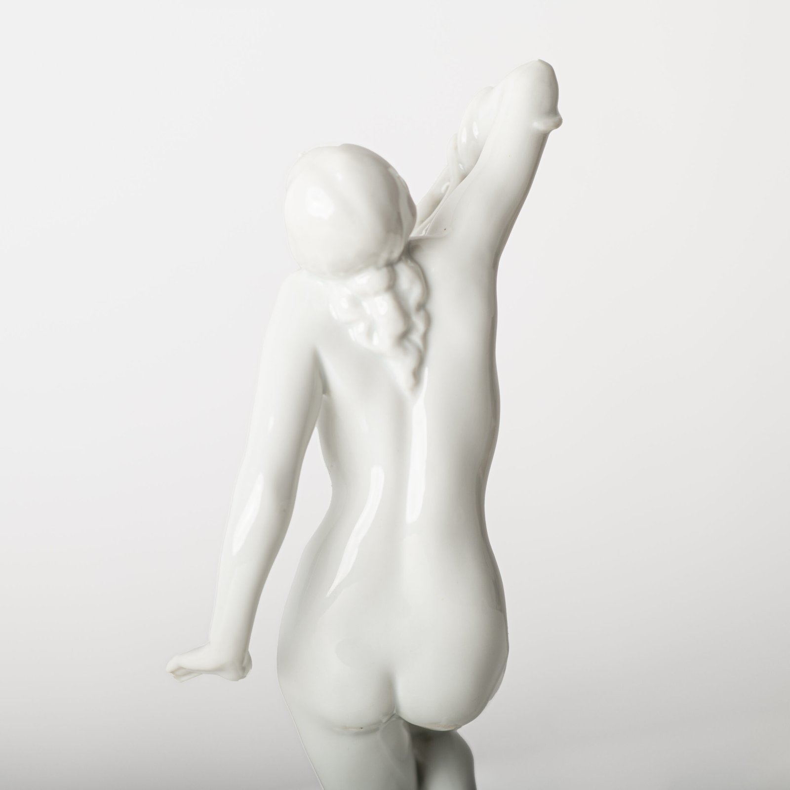 Art Deco porcelain sculpture of Cleopatra kneeling with a snake, in white glazed porcelain by Herend, signed in relief by sculptor Szigethy Nagy István, circa 1930.