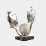 Original French Art Deco table lamp ca. 1930, signed by M. Font on both silvered metal fish figures, with sculptural design, frosted glass globe, and black Portoro marble base with natural golden veining. Measures 12.2 in high, 13.4 in wide, and 4.3 in deep.