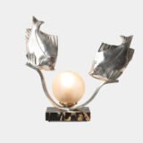 Original French Art Deco table lamp ca. 1930, signed by M. Font on both silvered metal fish figures, with sculptural design, frosted glass globe, and black Portoro marble base with natural golden veining. Measures 12.2 in high, 13.4 in wide, and 4.3 in deep.